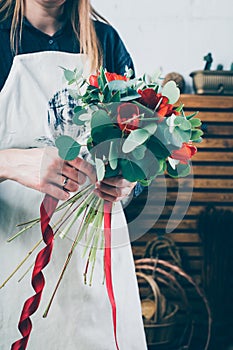 Red tulip in brides flower bouquet