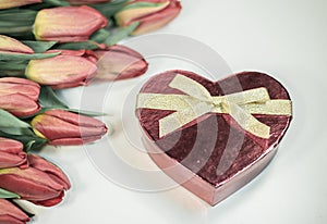 Red tulips with heart gift isolated on white background