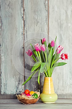 Red tulips and plate with eggs