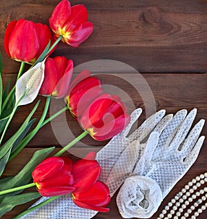 Red tulips and white lace gloves