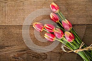 Red tulips on the wood