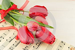 Red tulips on a wooden table