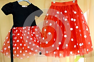 Red tulle skirt with white satin circles on a wide red elastic band.