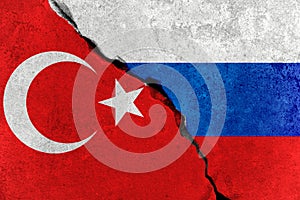Red turkey flag on broken damage wall and half russian white red blue color flag, relationship crisis between russia and turkey