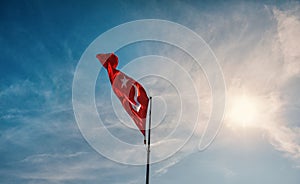 Red Turkish flag against blue sky