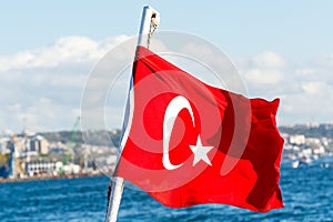 Red Turkish National flag on a cruise ship sailing on  the Bosphorus strait, Istanbul,Turkey