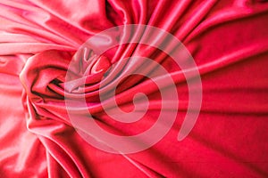 Red twisted silk or satin luxury fabric texture can use as abstract background. Top view