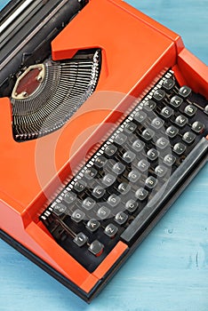 Red typewriter on blue table