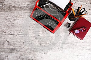 Red typewriter on the table with the office.