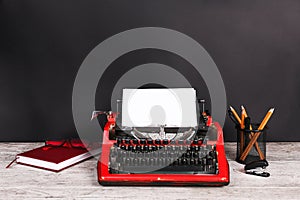 Red typewriter on the table with the office.