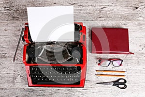 Red typewriter on the table with the office.