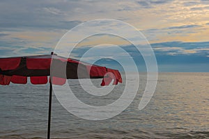 Red Umbrella on the beach and Beautiful sunset and sky of the sea.