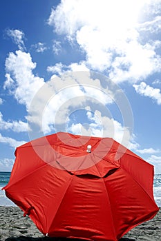 Red umbrella at beach - front view