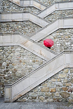 Red umbrella on the beautiful stairs to Bratislava castle, Slovakia