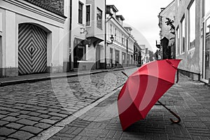 Red umbrella on cobblestone street in the Tallinn old town.