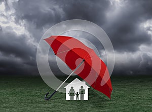 Red umbrella covering home and family under rain, insurance