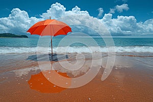 A red umbrella on a deserted beach against the background of the sea