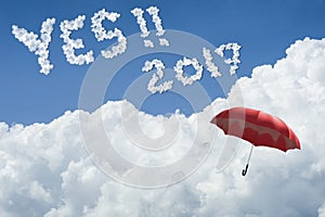 Red umbrella floating above against Blue sky and cloud.Sunny day.Cloudscape.close up the cloud.text YES 2017. hope to success