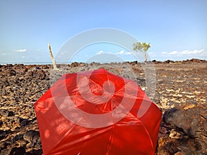 Red umbrella on the Pasir Padi Beach.