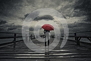 Red umbrella in storm photo