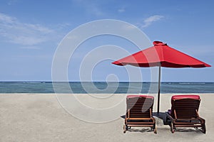 Red umbrella and two chairs