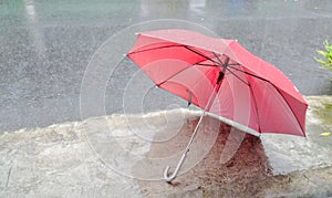 Red umbrella under the rainstorm