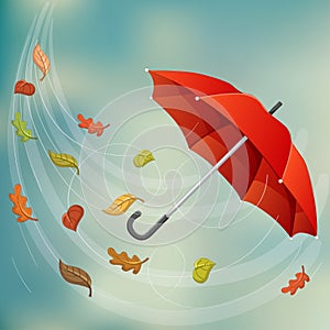 Red umbrella in wind with autumn leaf