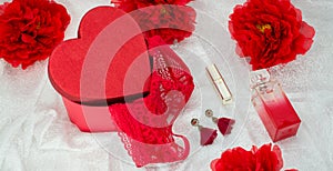 Red underwear knickers in gliter red box heart shaped perfume  roses juwelery  on white background