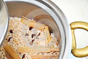 Red unpolished rice with beans in pot