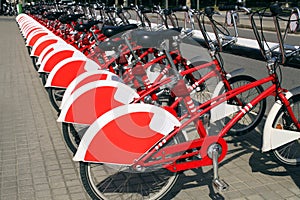 Red urban bicycles parked in european city