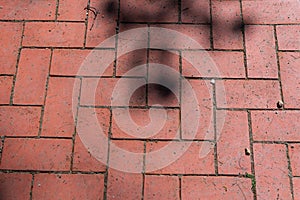 Red urban pavers are arranged symmetrically