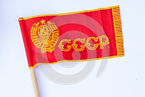 Red ussr flag on a stick on an isolated white background since soviet times