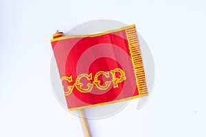 Red ussr flag on a stick on an isolated white background since soviet times