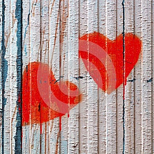 Red Valentine loving hearts on an old wooden fence