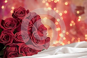 Red valentine roses bouquet with white feathers photo
