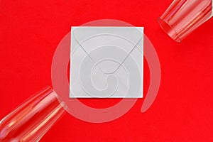 Red valentine`s day background envelope and wine glasses
