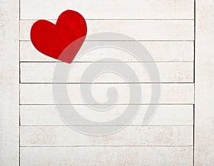 A Red Valentines Day Heart on Rustic White Wood Boards Background with room or space for copy, text or your words.  It`s a horizo photo