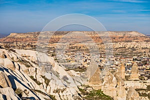 Red Valley and Rose Valley and downtown of Goreme under the sunlight in daytime in Cappadocia, Turkey.. Rock formations that