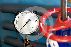 Red valve and pressure sensor on the gas supply or heating pipe.