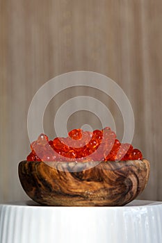 Red vegan caviar from kelp seaweed in a wooden bowl. Valuable and useful product for a healthy diet. Superfood. Close-up