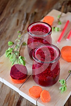 Red vegetable smoothie in glass jars