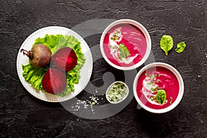 Red vegetarian beet root soup with sour cream and raw beets