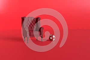 Red velvet armchair of old design on short legs with a football ball on red background. 3d rendering