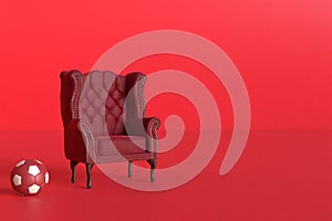 Red velvet armchair of old design on short legs with a soccer ball on black background. 3d rendering