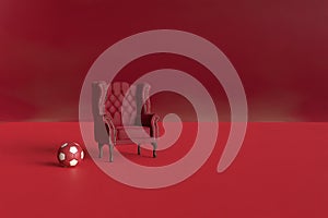 Red velvet armchair of old design on short legs with a soccer ball on black background. 3d rendering