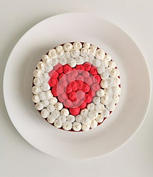 Red velvet cake in the shape of a heart on a white background on the table. Sweet dessert for valentine's day and