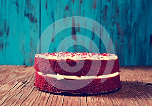 Red velvet cake on a wooden table, filtered