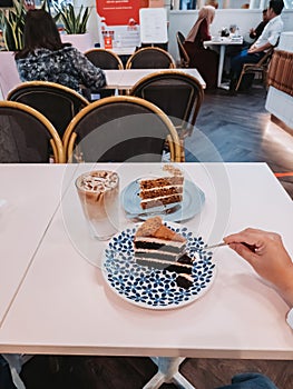 Red velvet and carrot cakes on the table with iced latte for tea time in  IOI City Mall