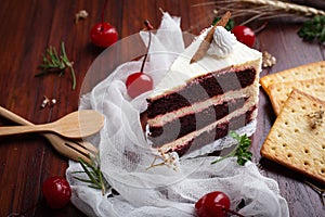 Red velvet cheese cake with cherry and Biscuits on wooden table