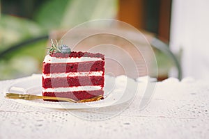 Red velvet cream layer cake closeup on the cafe table, desser food sweet delicious vintage tone